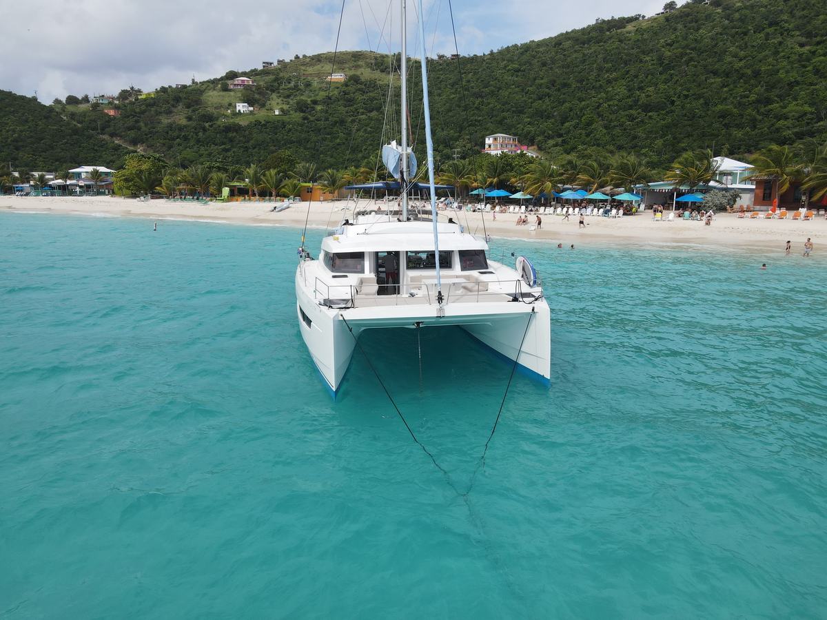 Aerial photo of the beach and calm bay at Jost Van Dyke with Ne Plus Ultra at anchor